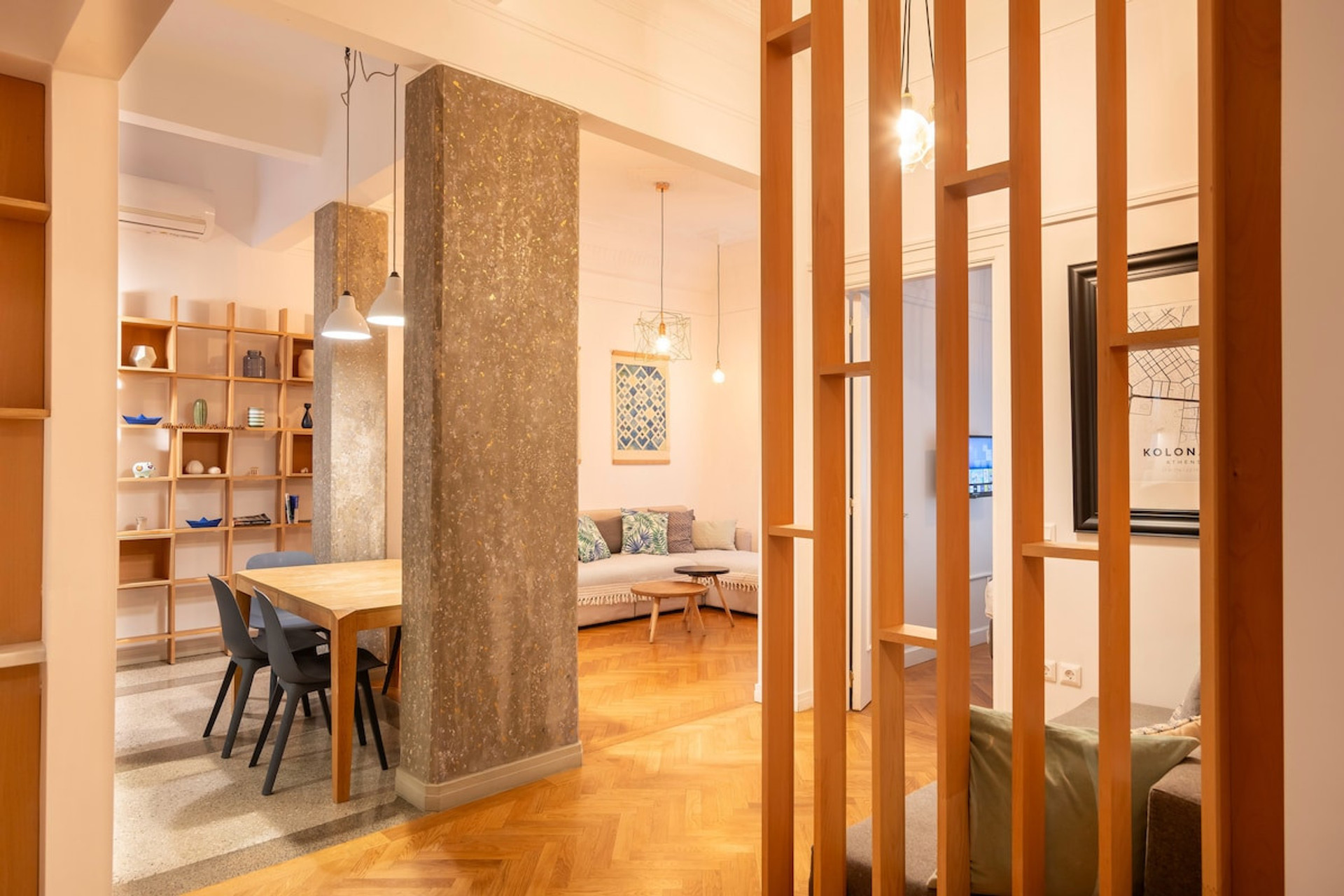 A warm and inviting open-plan space with stylish wooden accents, a cosy seating area, and a modern dining setup. Perfect for relaxing or entertaining in a bright and elegant atmosphere.