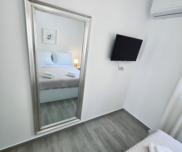 Bedroom with mirror and TV