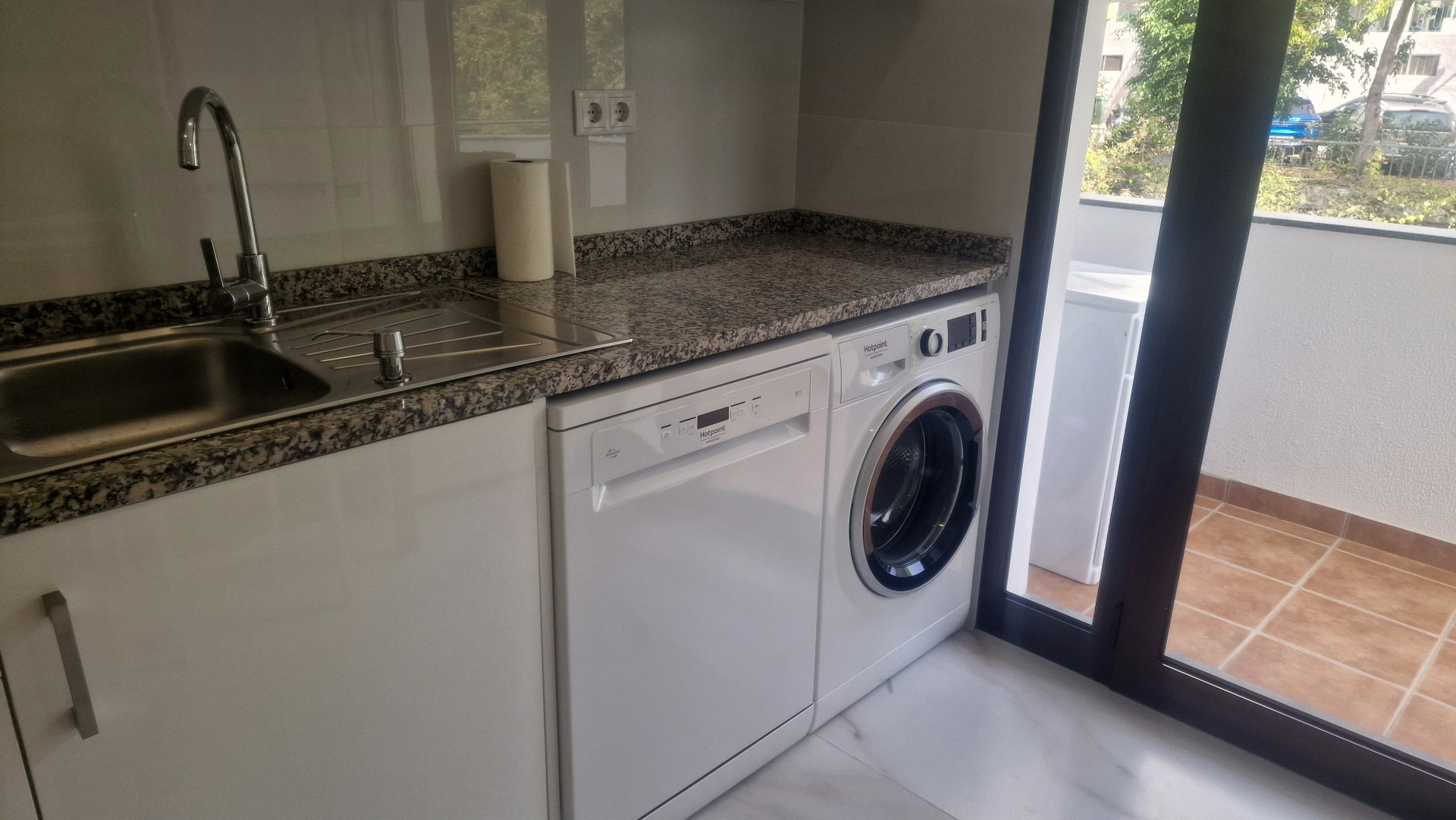 Laundry area with washer and sink
