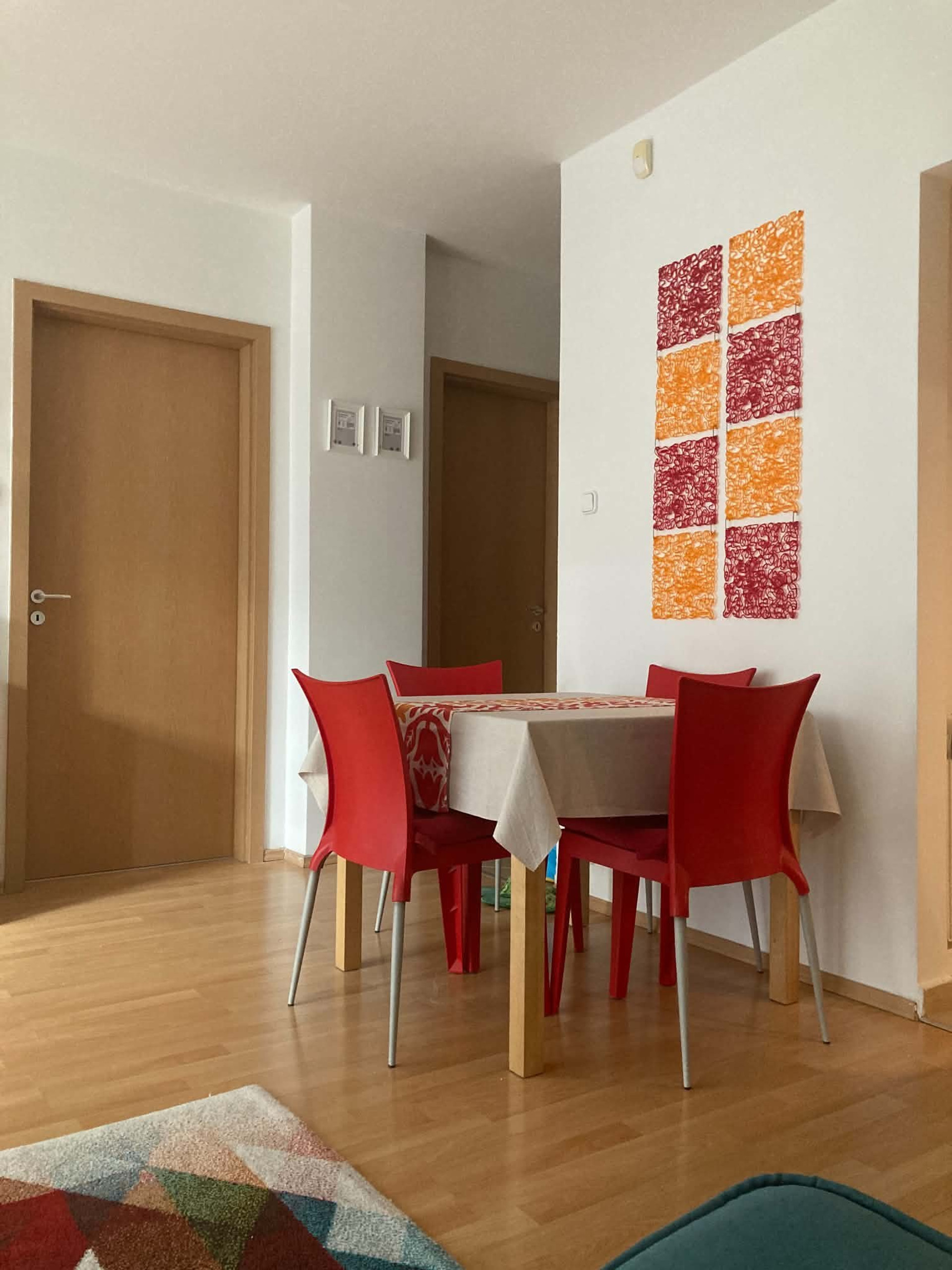Dining area with red chairs