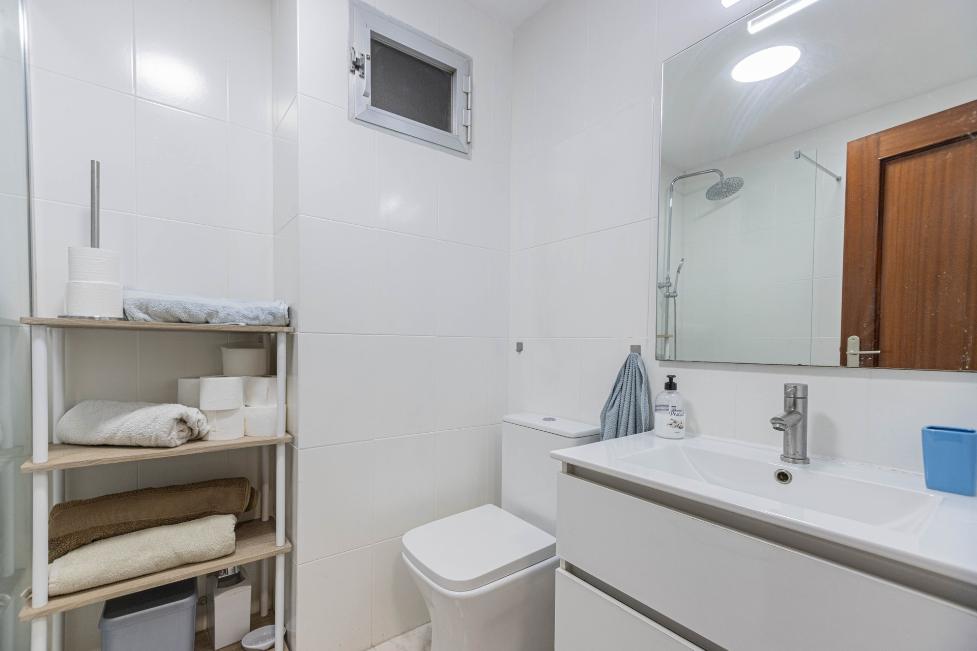 Bathroom with vanity and shelving