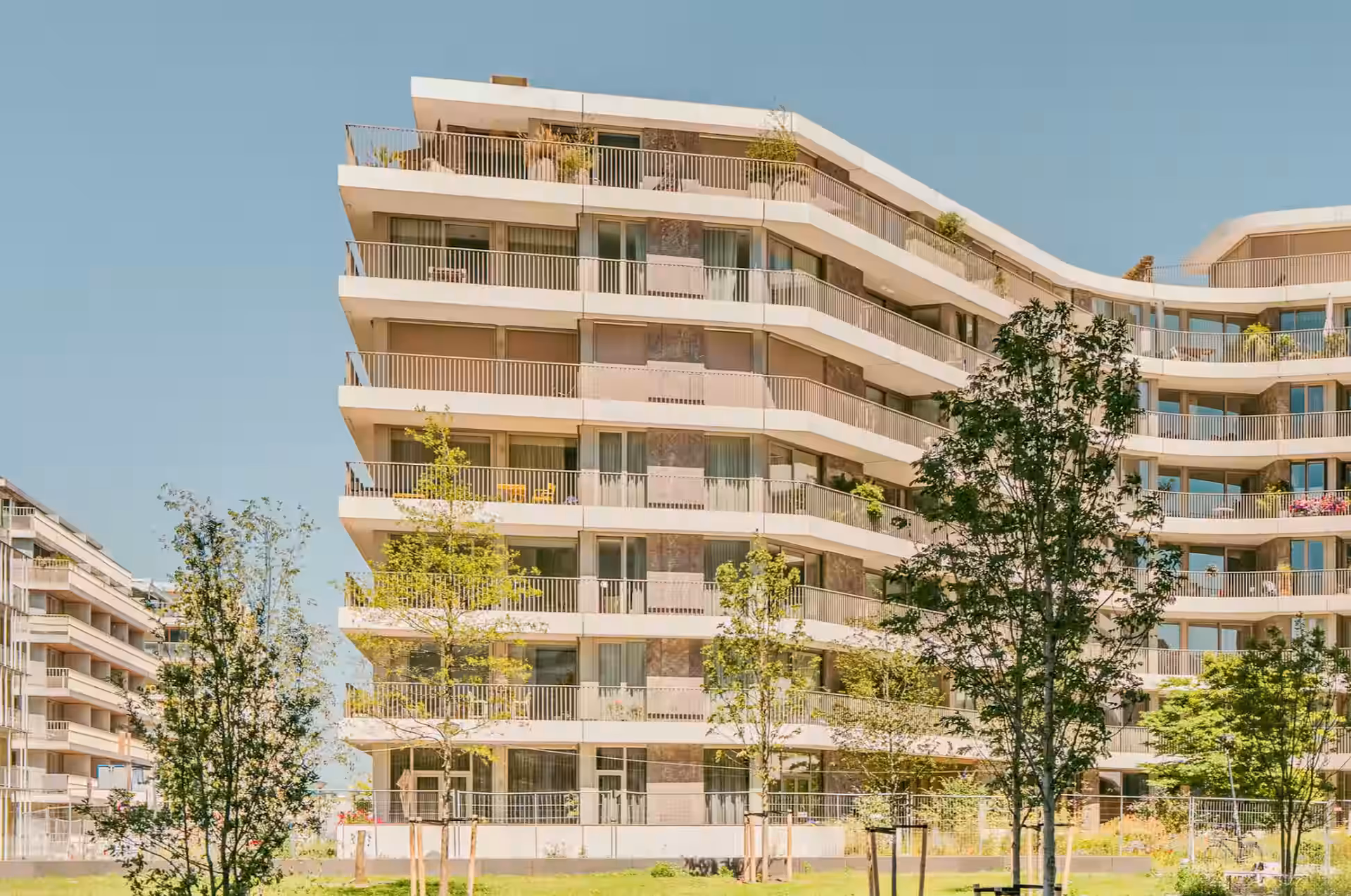 Building facade with balconies and trees