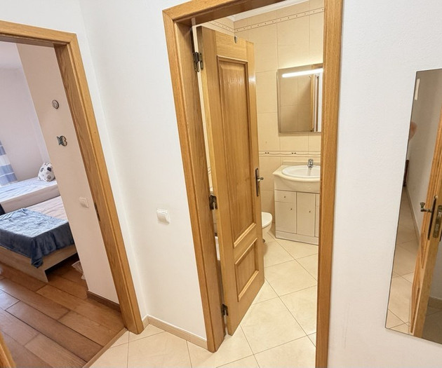 Hallway with bathroom and bedroom