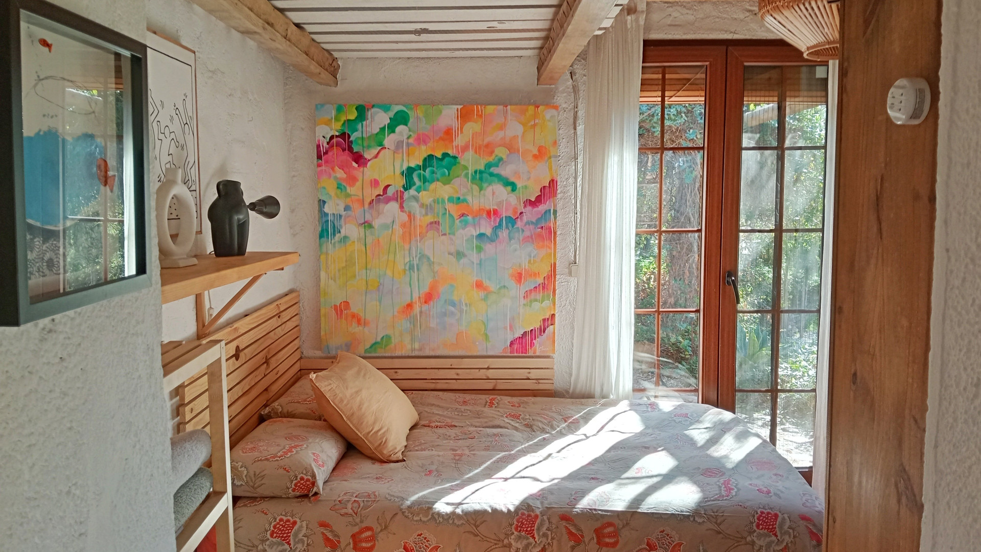 Bright bedroom with colorful wall art