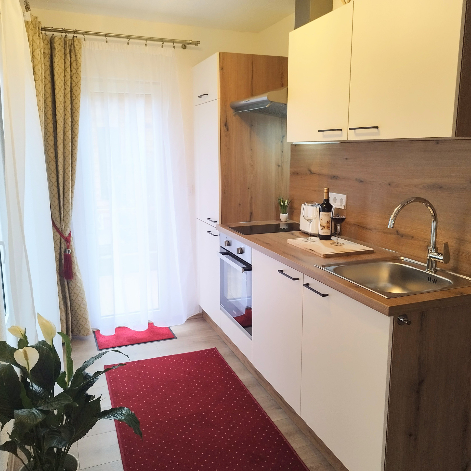 Compact kitchen with wine and stove