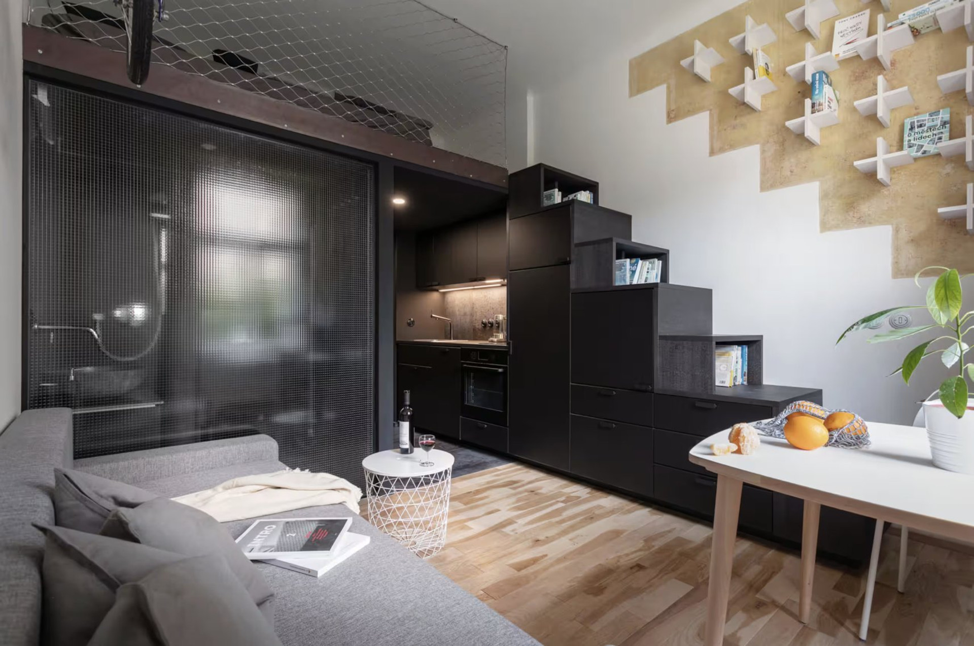 Living area with kitchen and staircase storage