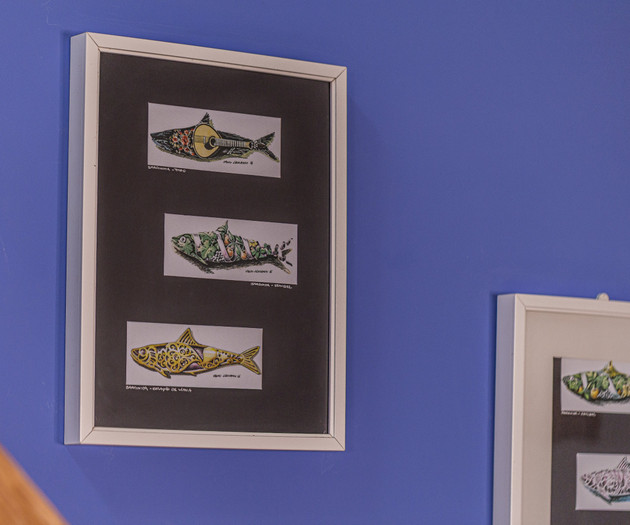 Framed sardine artwork on wall