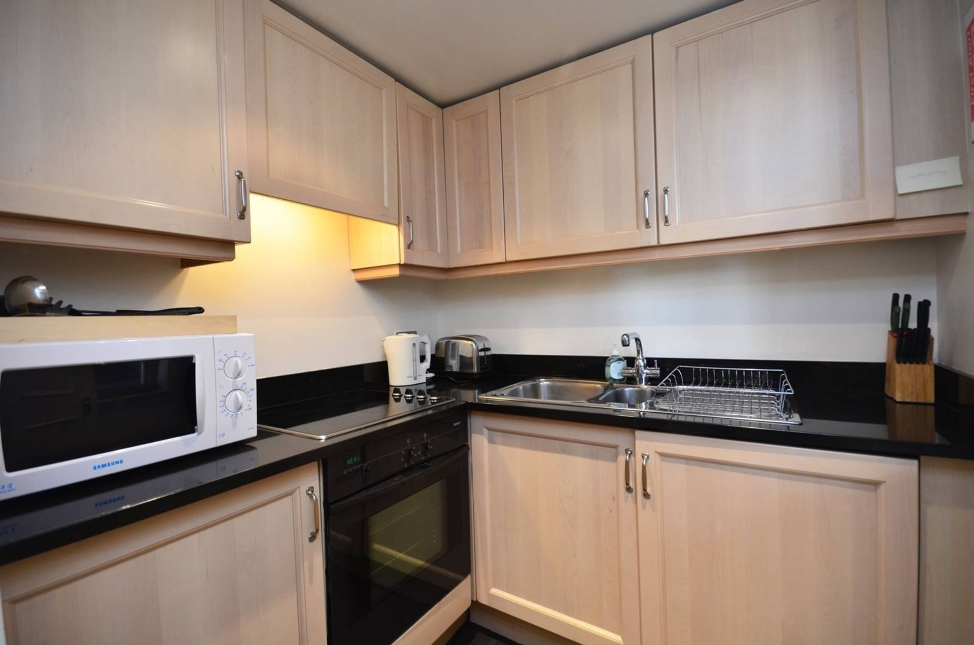 Compact kitchen with black countertops