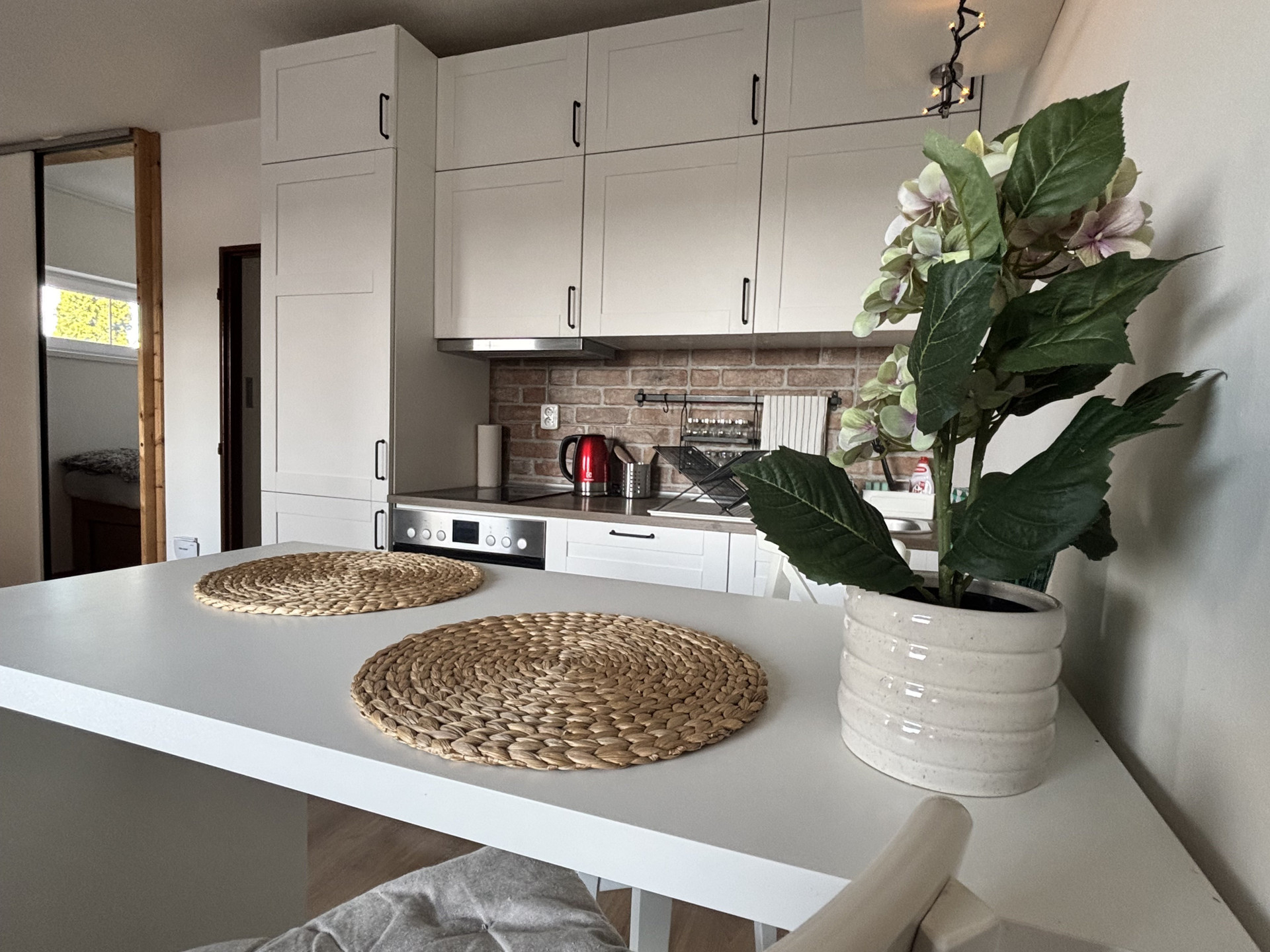 Kitchen with brick backsplash and cabinets