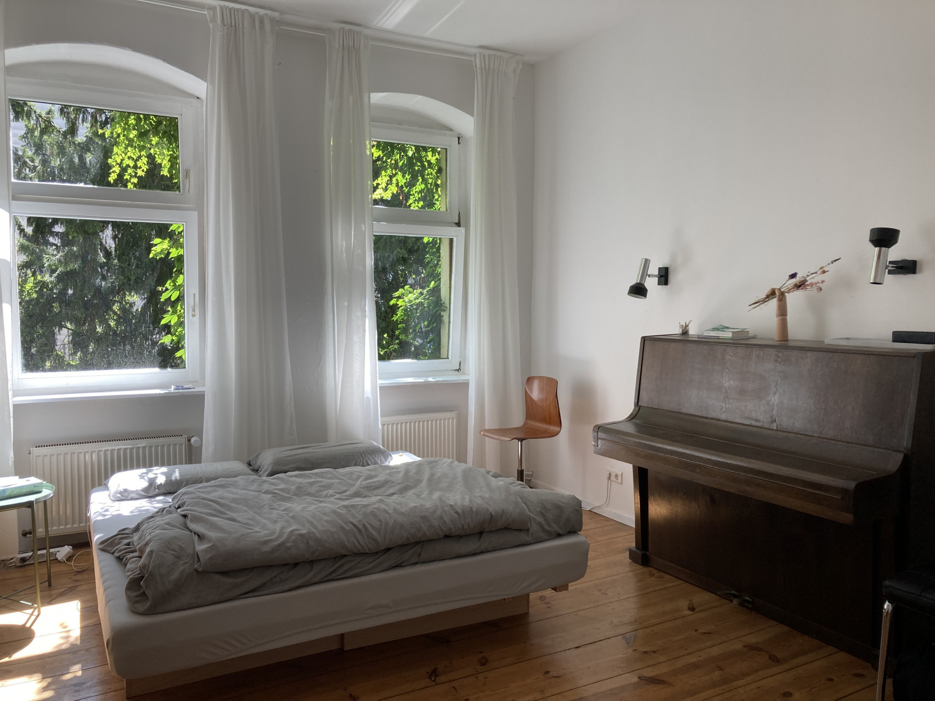 Bed, piano, and the green view out of the windows :)