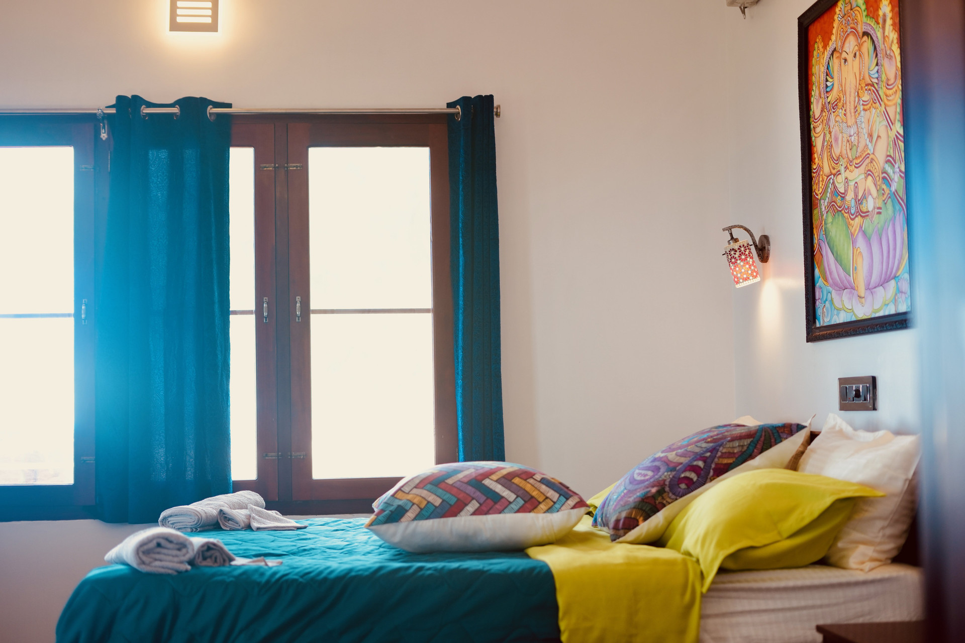 Bedroom with vibrant bedding and art