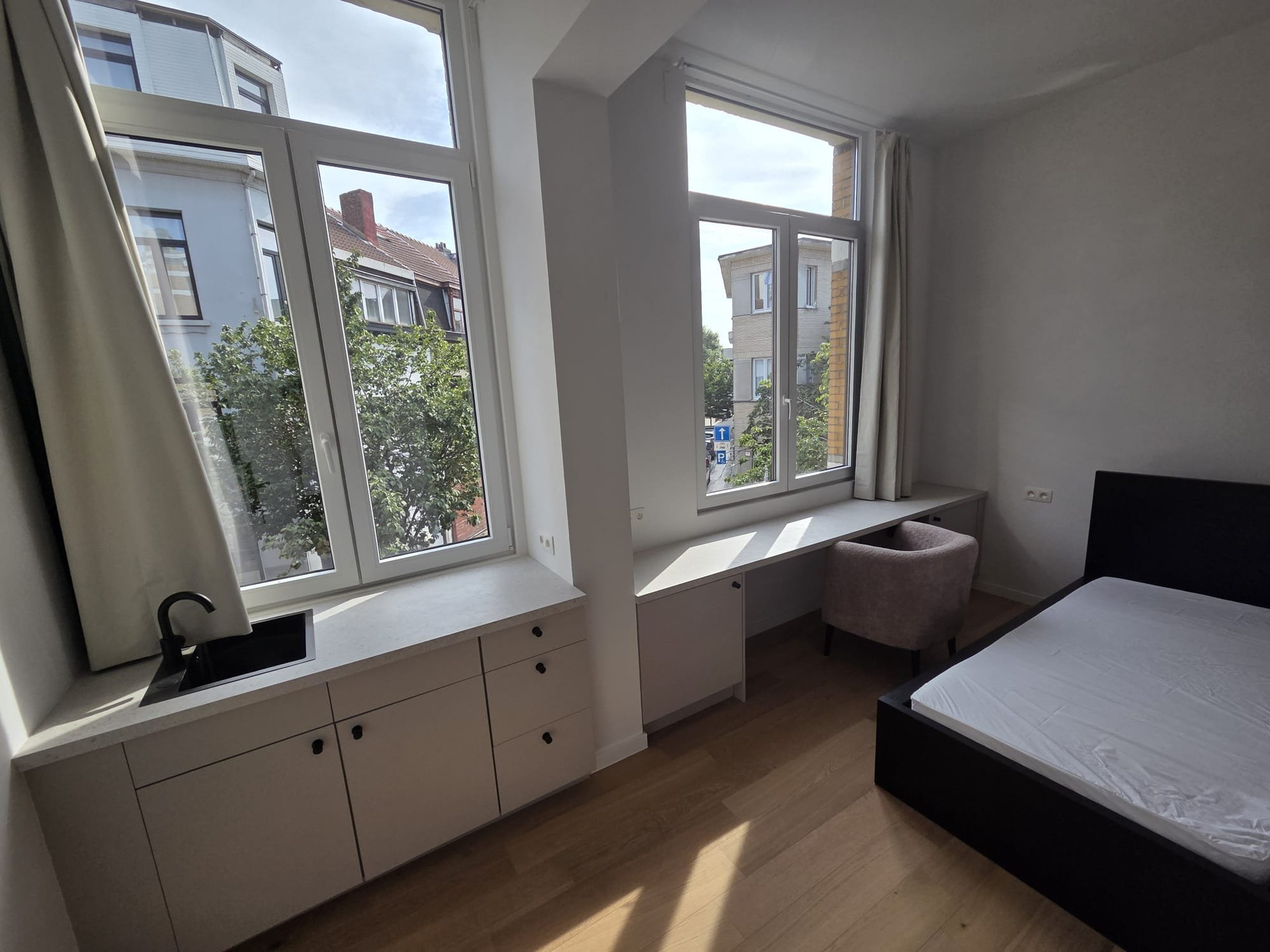 Bedroom with windows and desk area