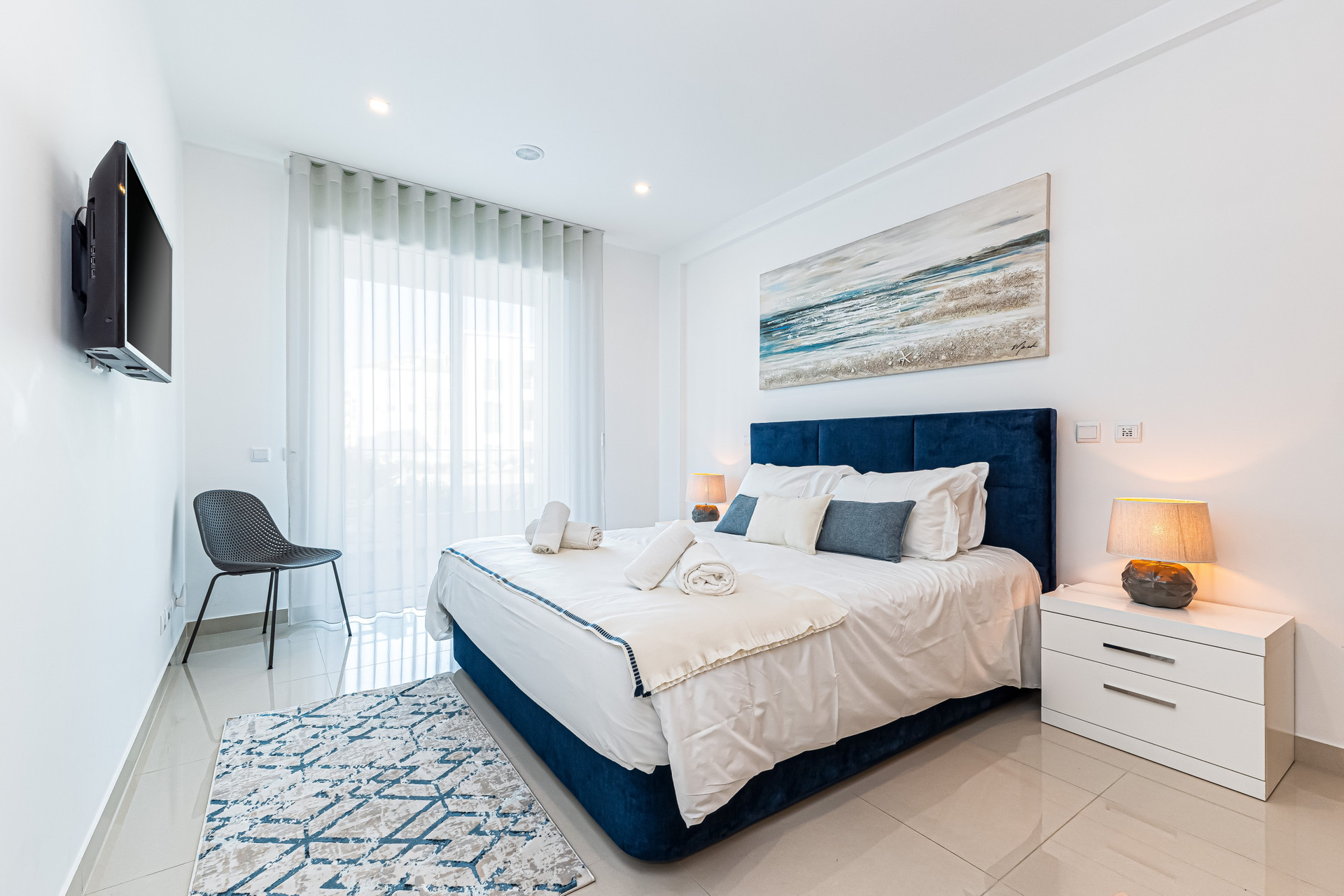 Bedroom with blue upholstered bed