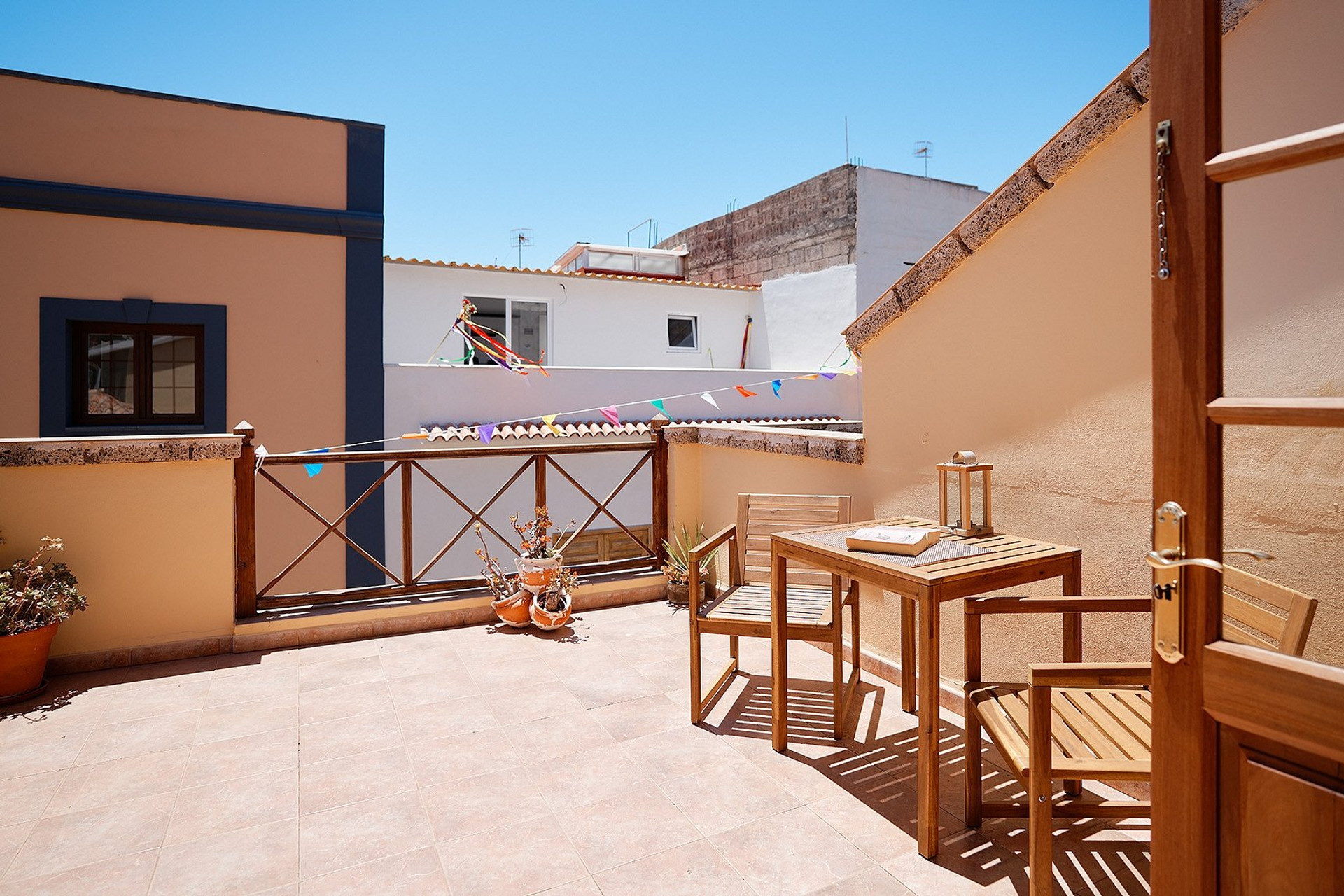Sunny terrace with wooden table