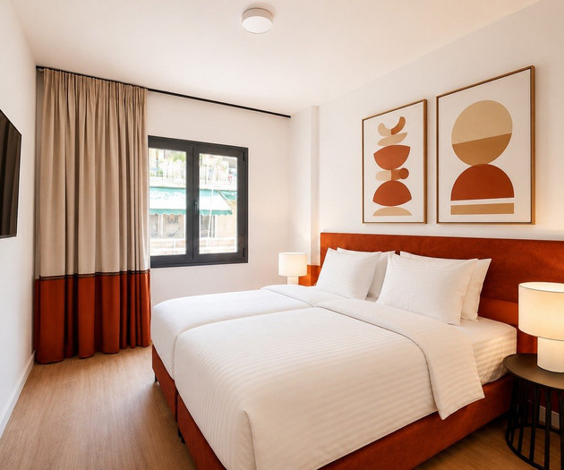 Twin bedroom with TV and art