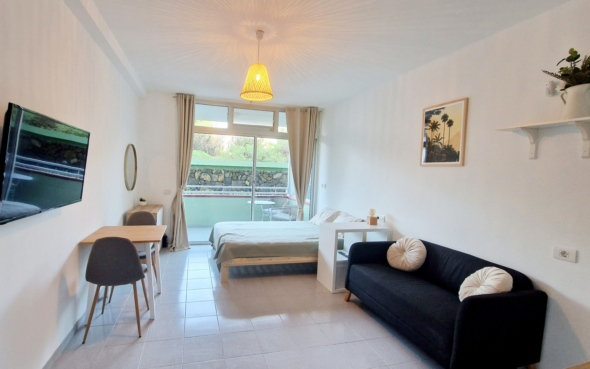Dining table, sofa and bed.