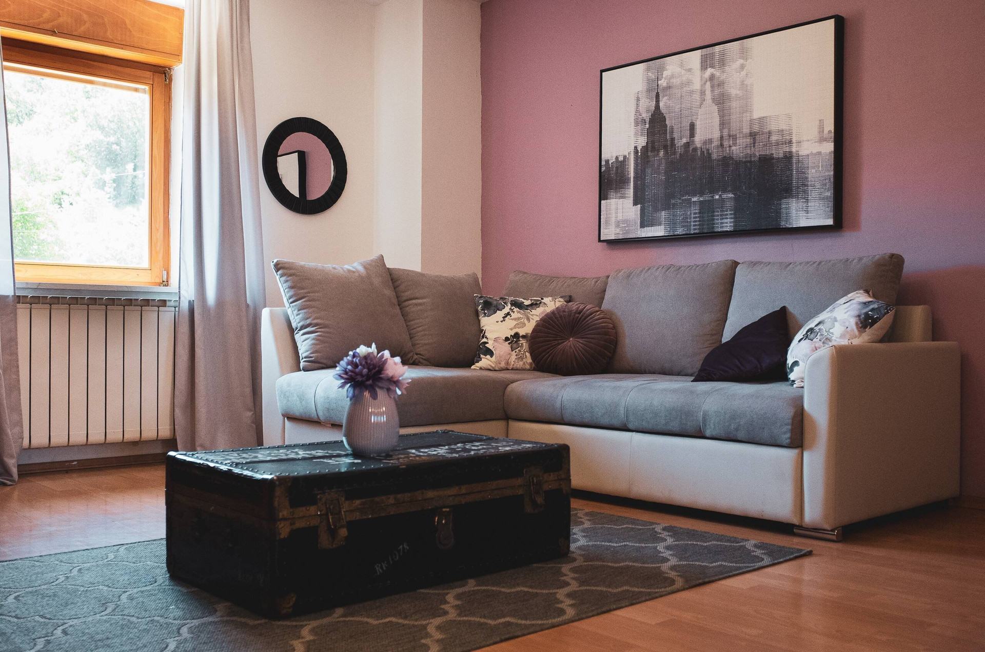 Living room sofa with pink accent wall