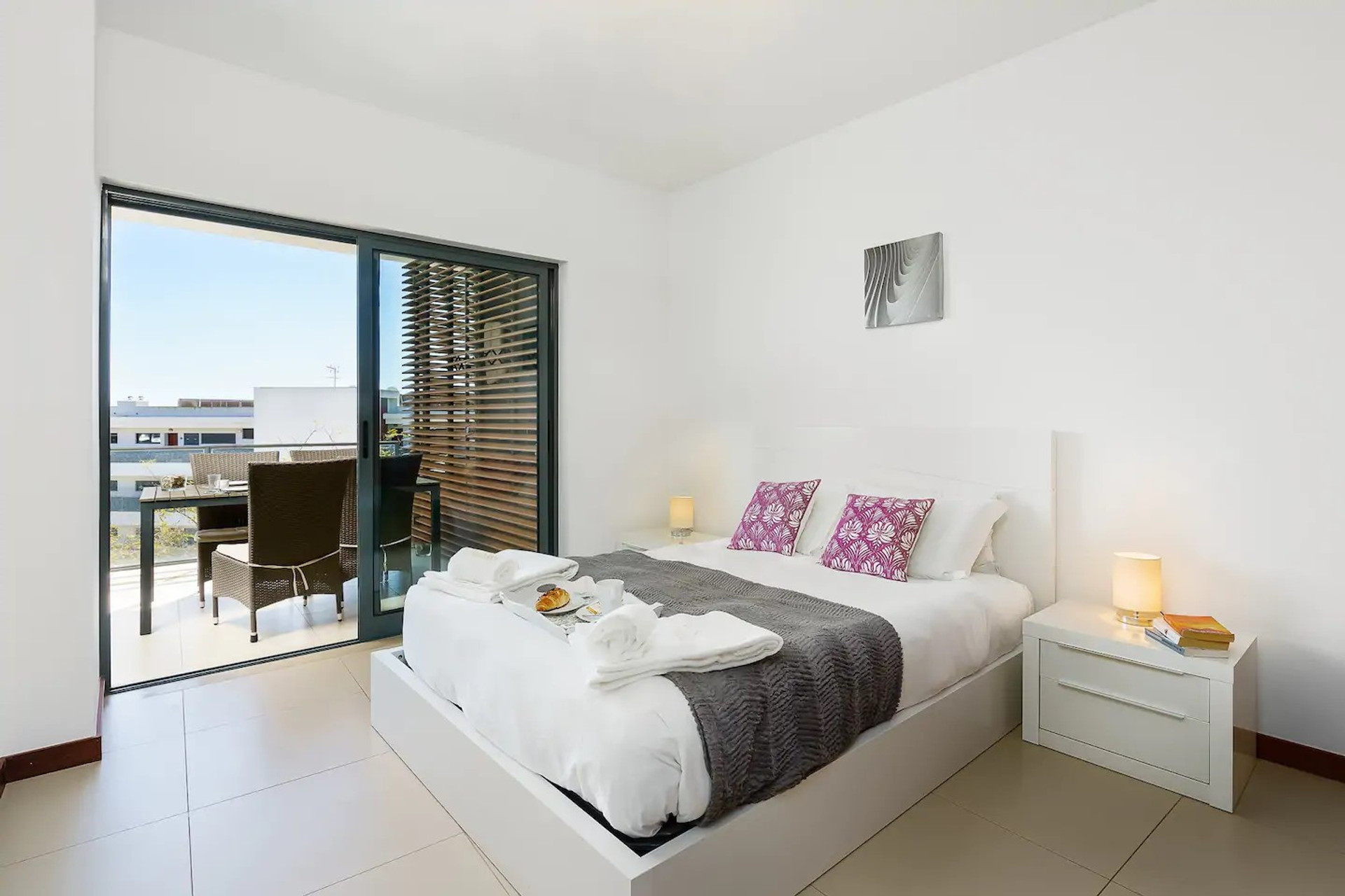 Bedroom with balcony access and city view