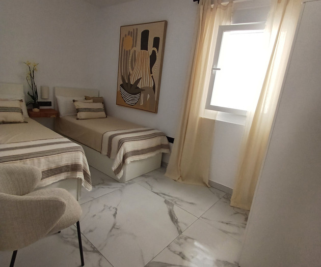 Twin bedroom with armchair