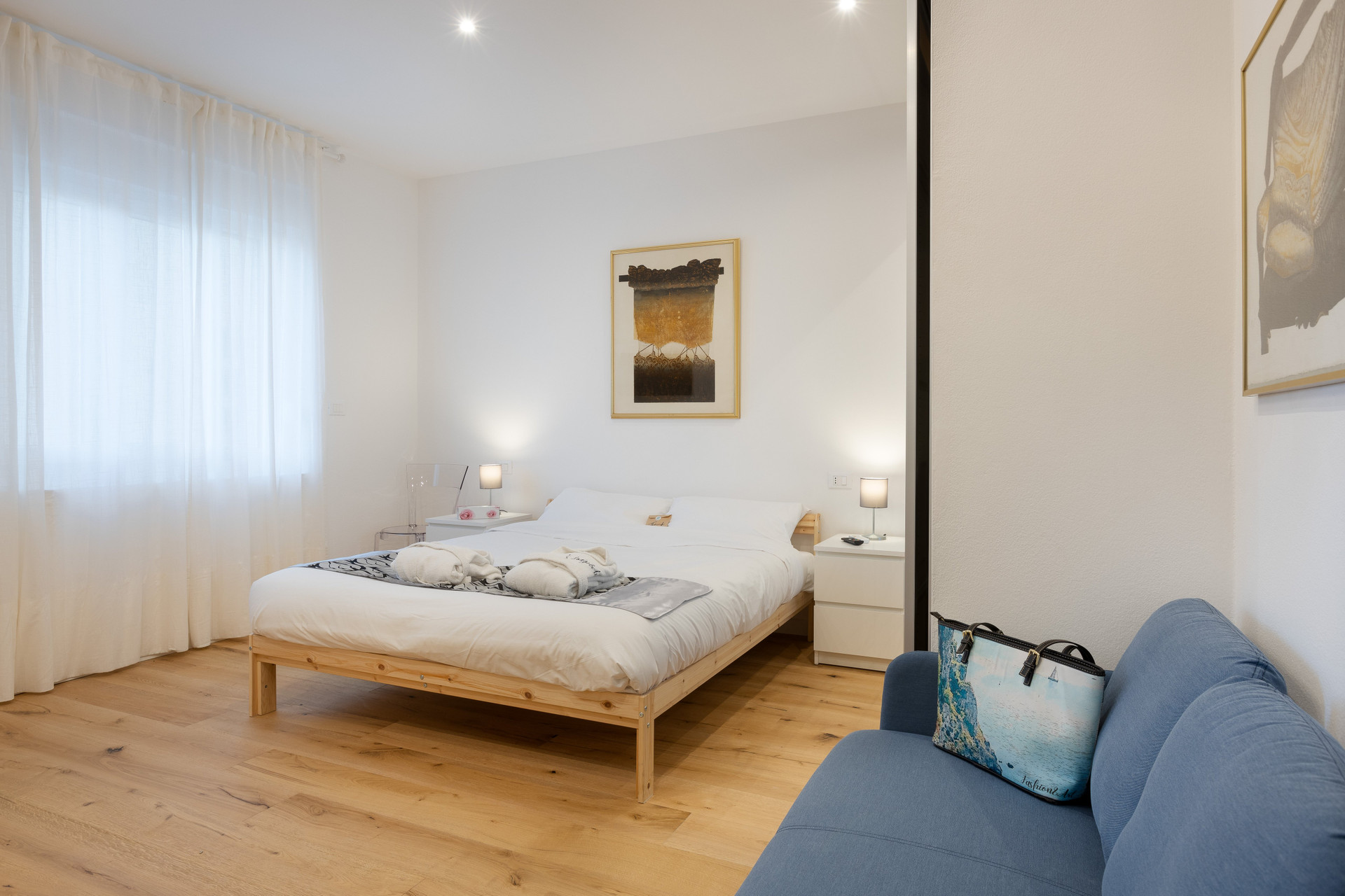 Double bed with blue sofa