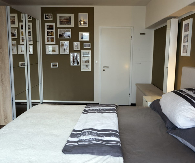 Bedroom with framed photos