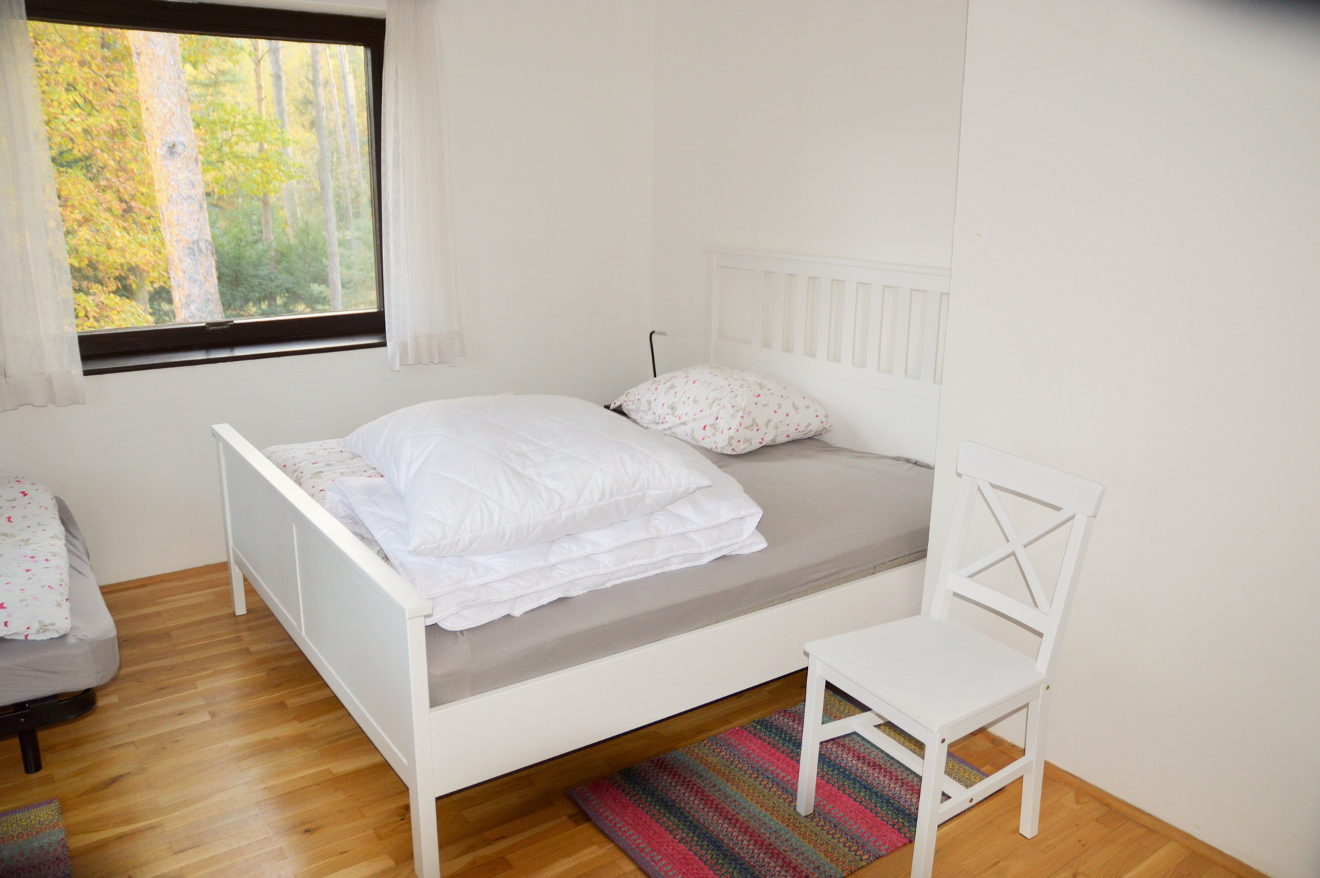 Bright double bedroom with chair