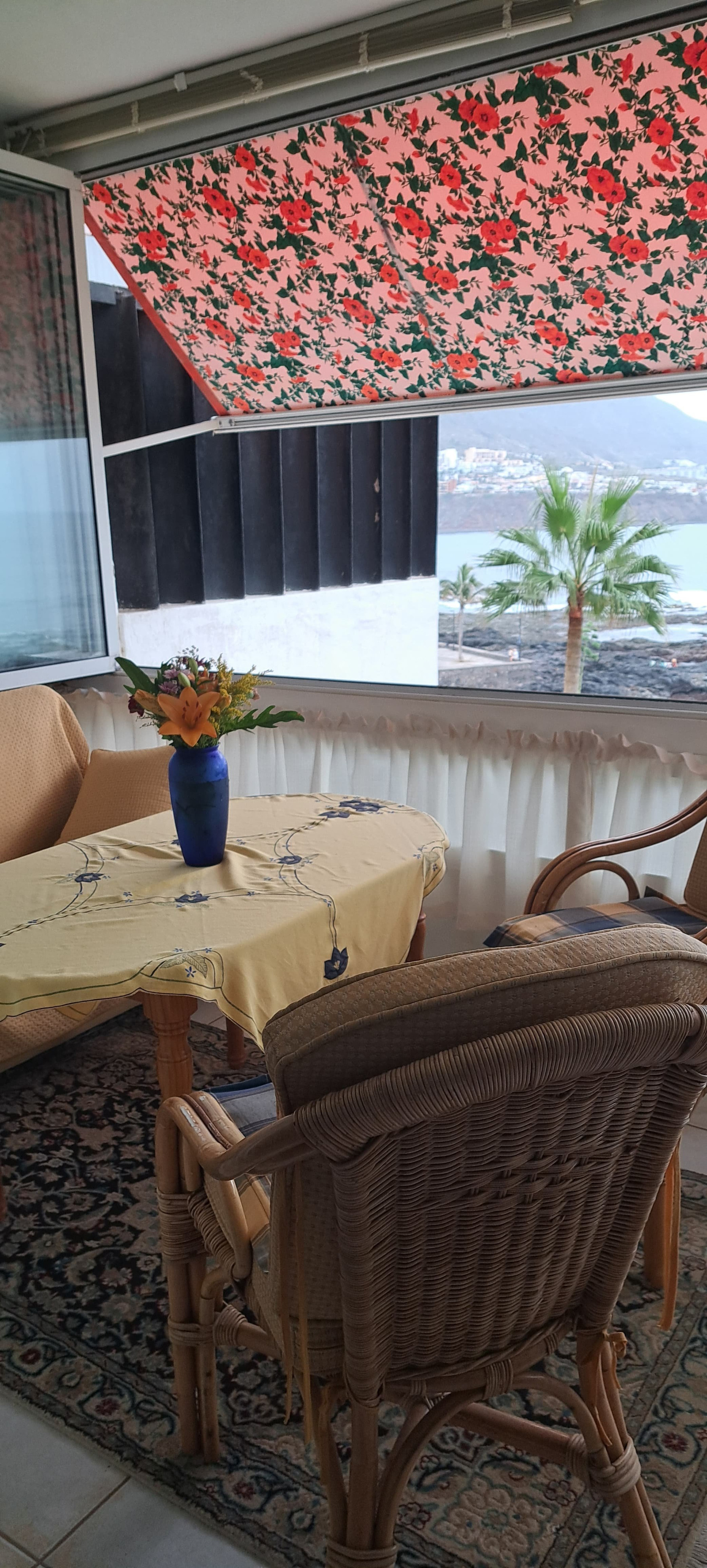 Enclosed terrace with wicker dining set