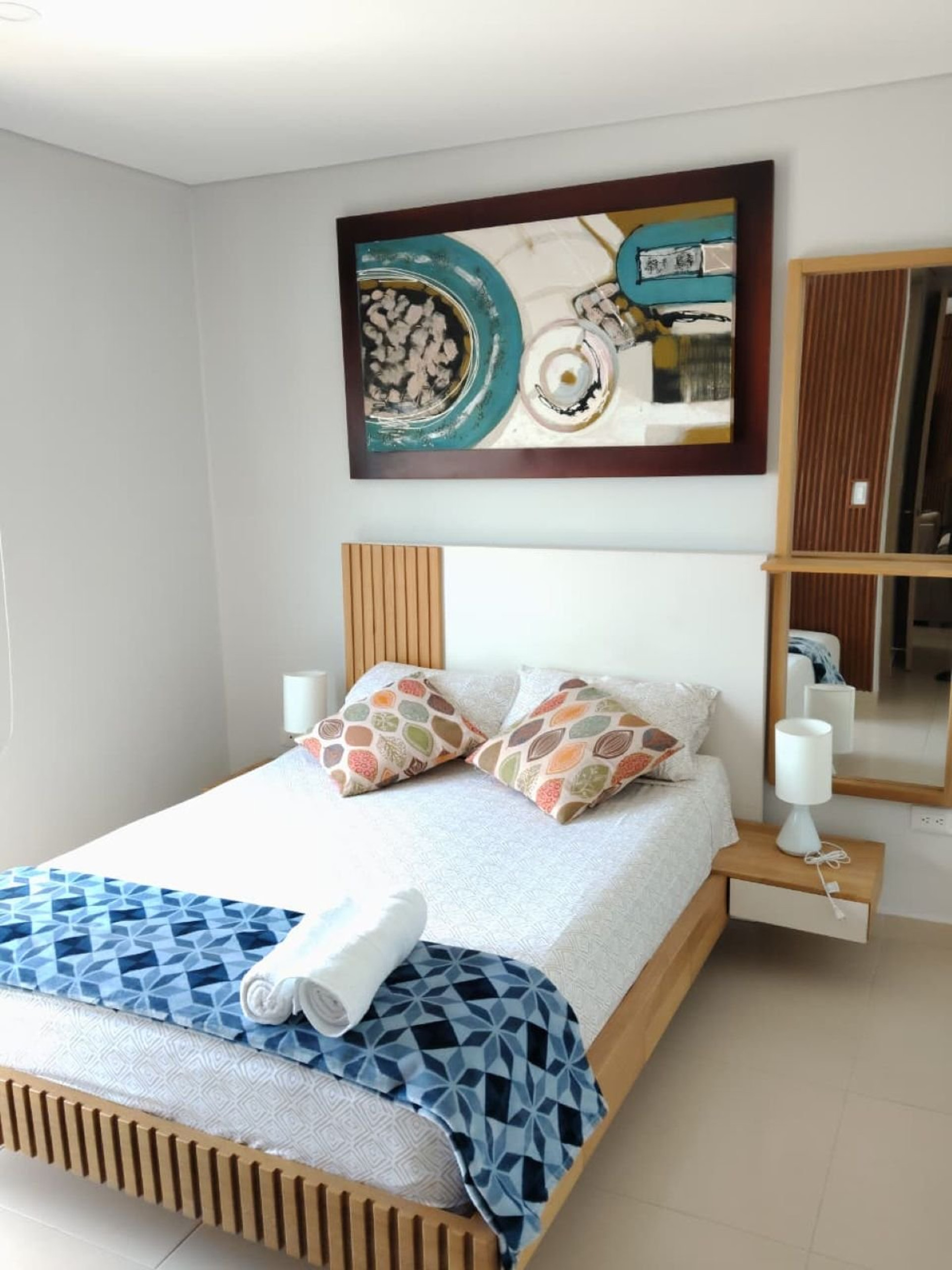 Bedroom with artwork above bed