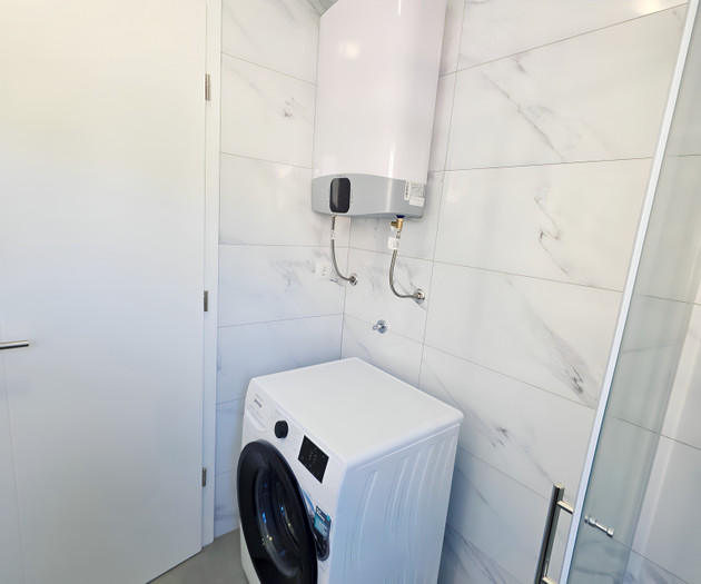 Laundry area with washer