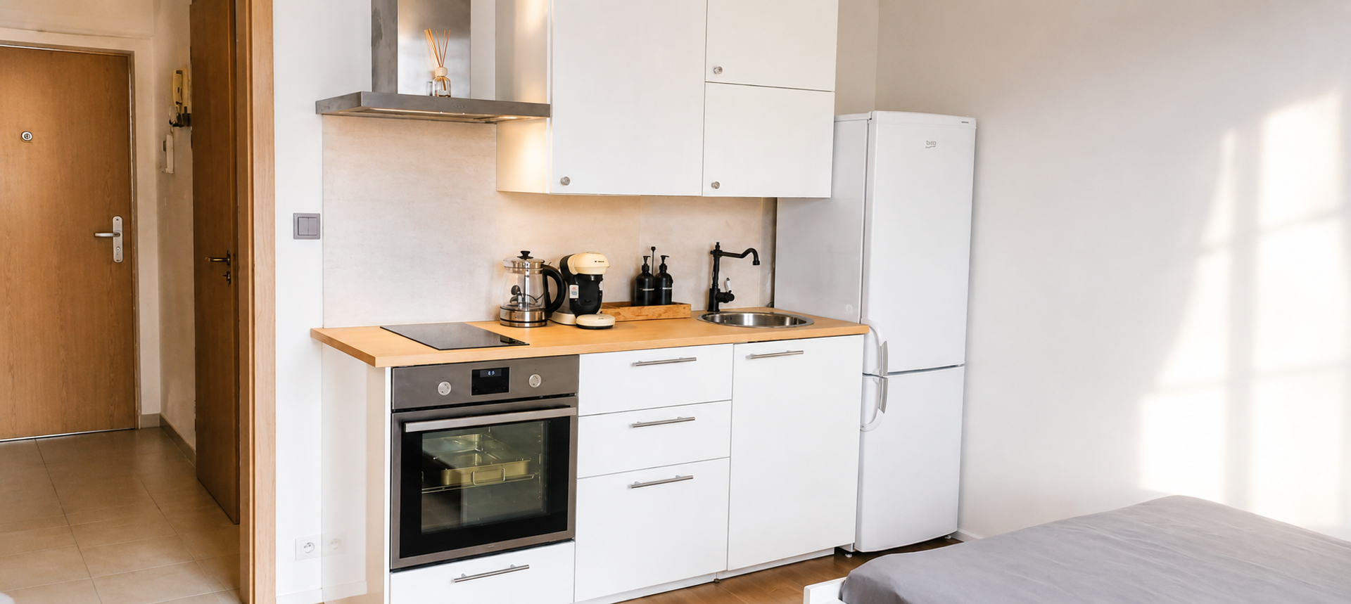 White kitchen with oven and fridge