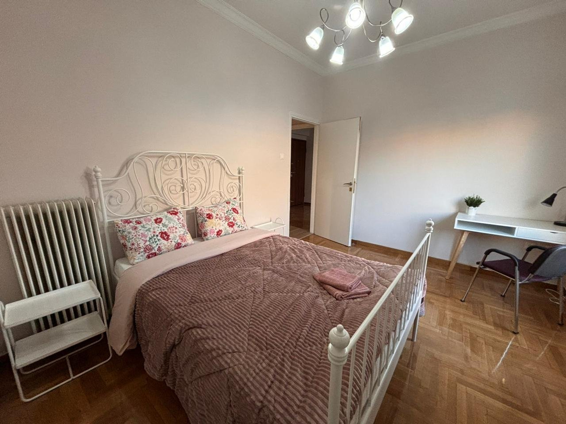Bedroom with ornate iron headboard