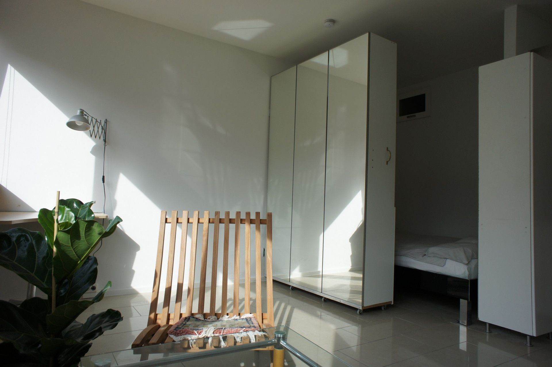 Mirrored wardrobe hides the bed during daytime