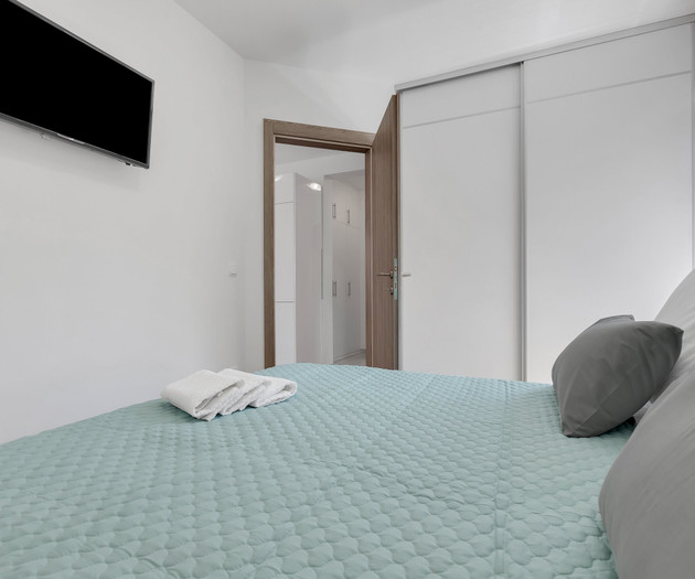 Bedroom with wardrobe and TV