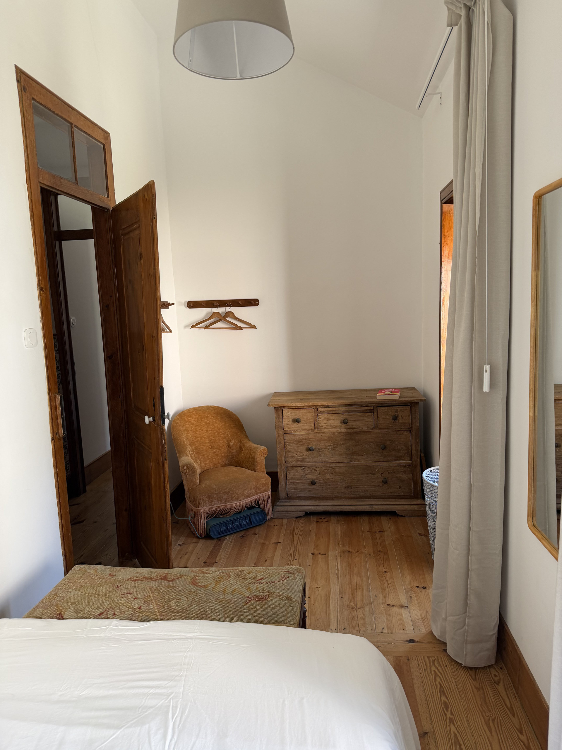 Bedroom with wardrobe and armchair