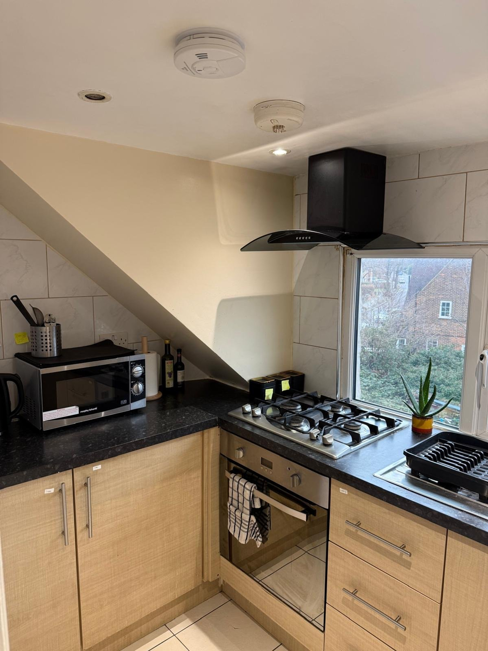 Kitchen with gas hob and hood