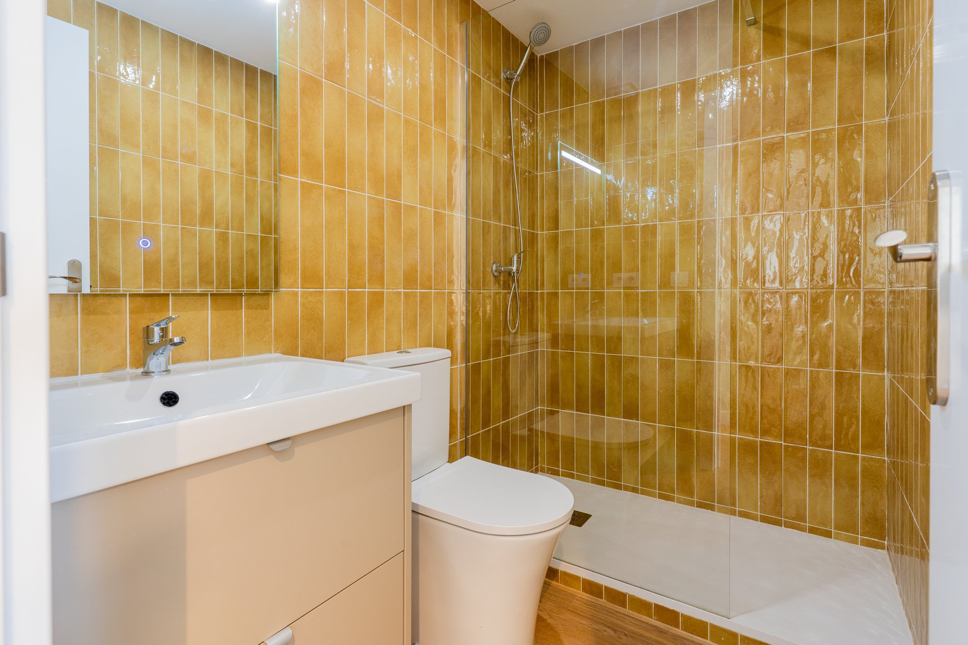 Bathroom with golden tiles and shower