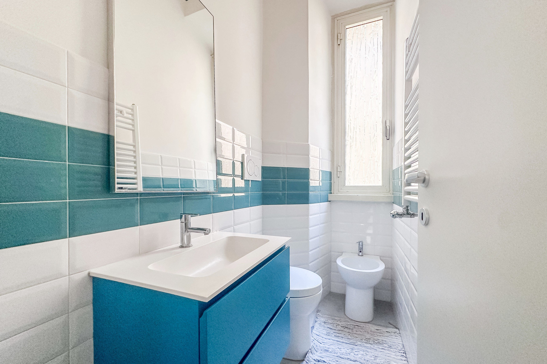 Bright bathroom with blue tiles