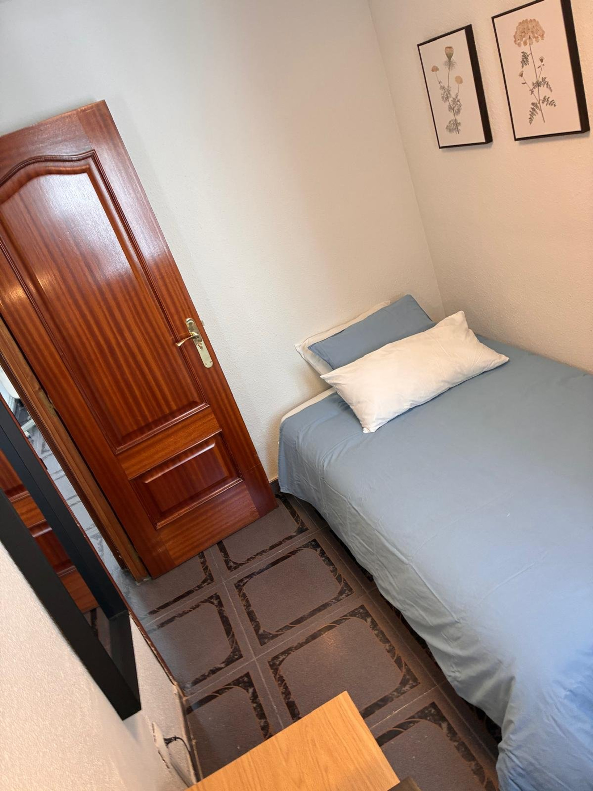 Bedroom view with door and bed