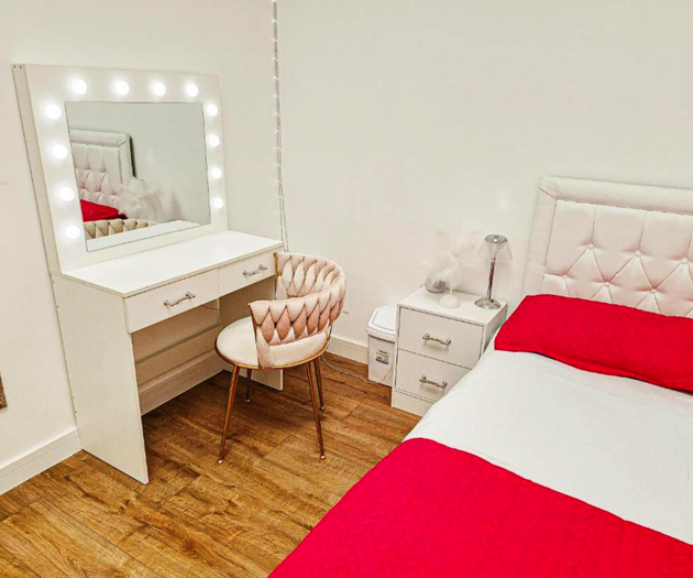 Bedroom with vanity mirror and desk