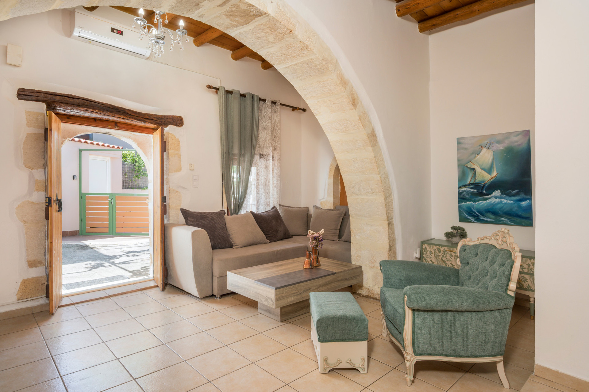 The living room on the ground floor features a comfortable sofa that easily converts into a double bed.