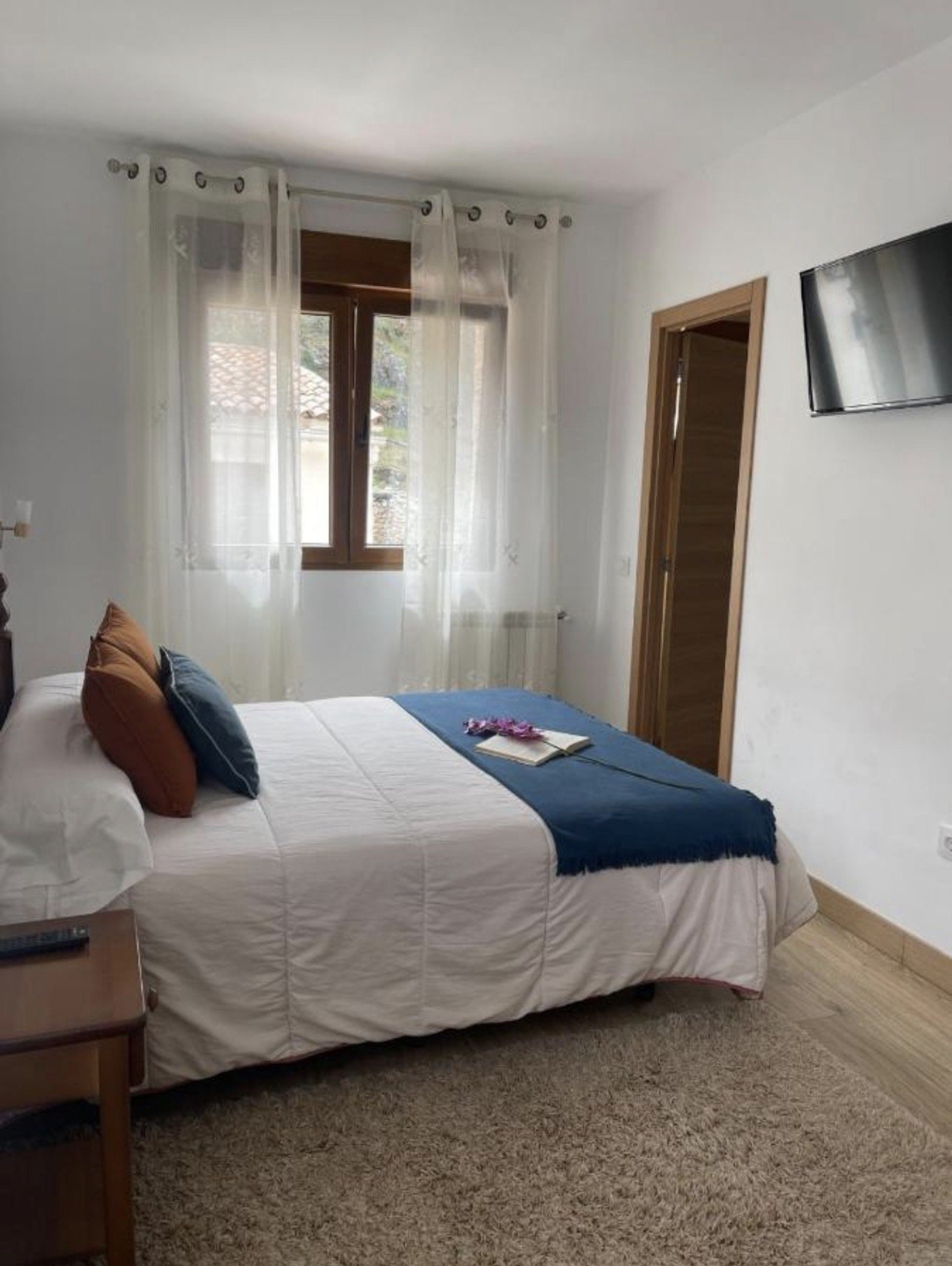 Double bedroom with blue throw