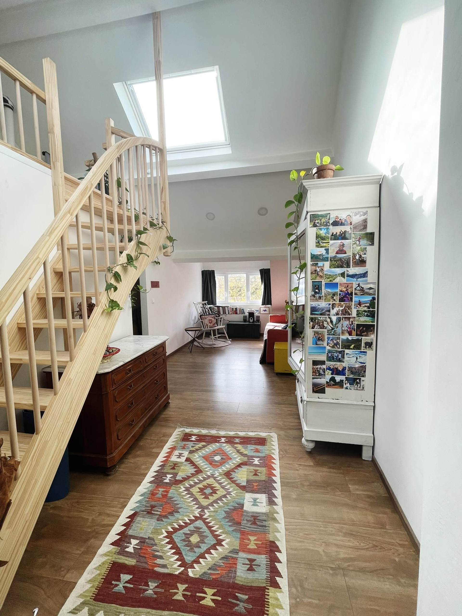 Bright hallway with staircase and rug