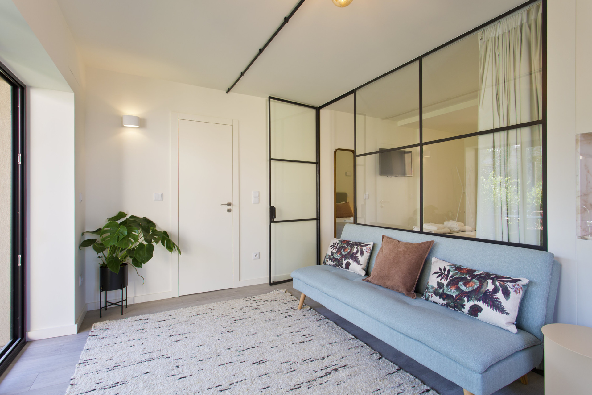 Living room blue sofa glass partition