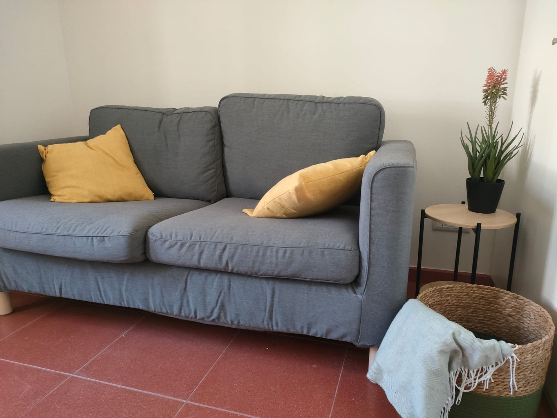 Grey sofa with yellow cushions