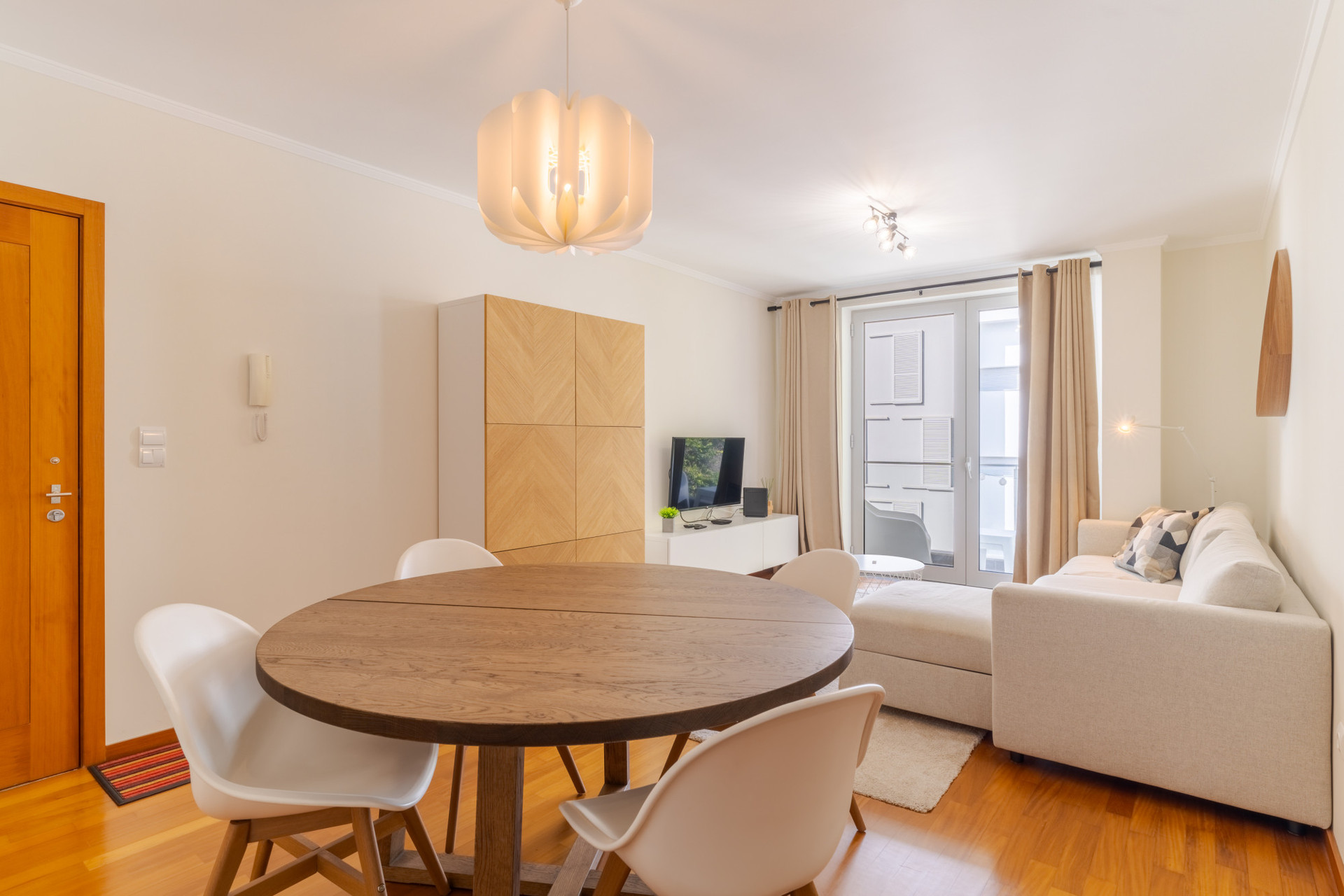 Living room with dinning table, sofa and television