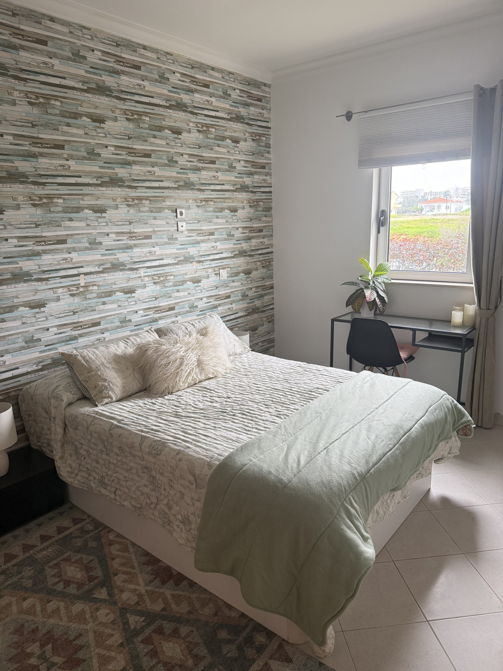 Bedroom with accent wall and desk