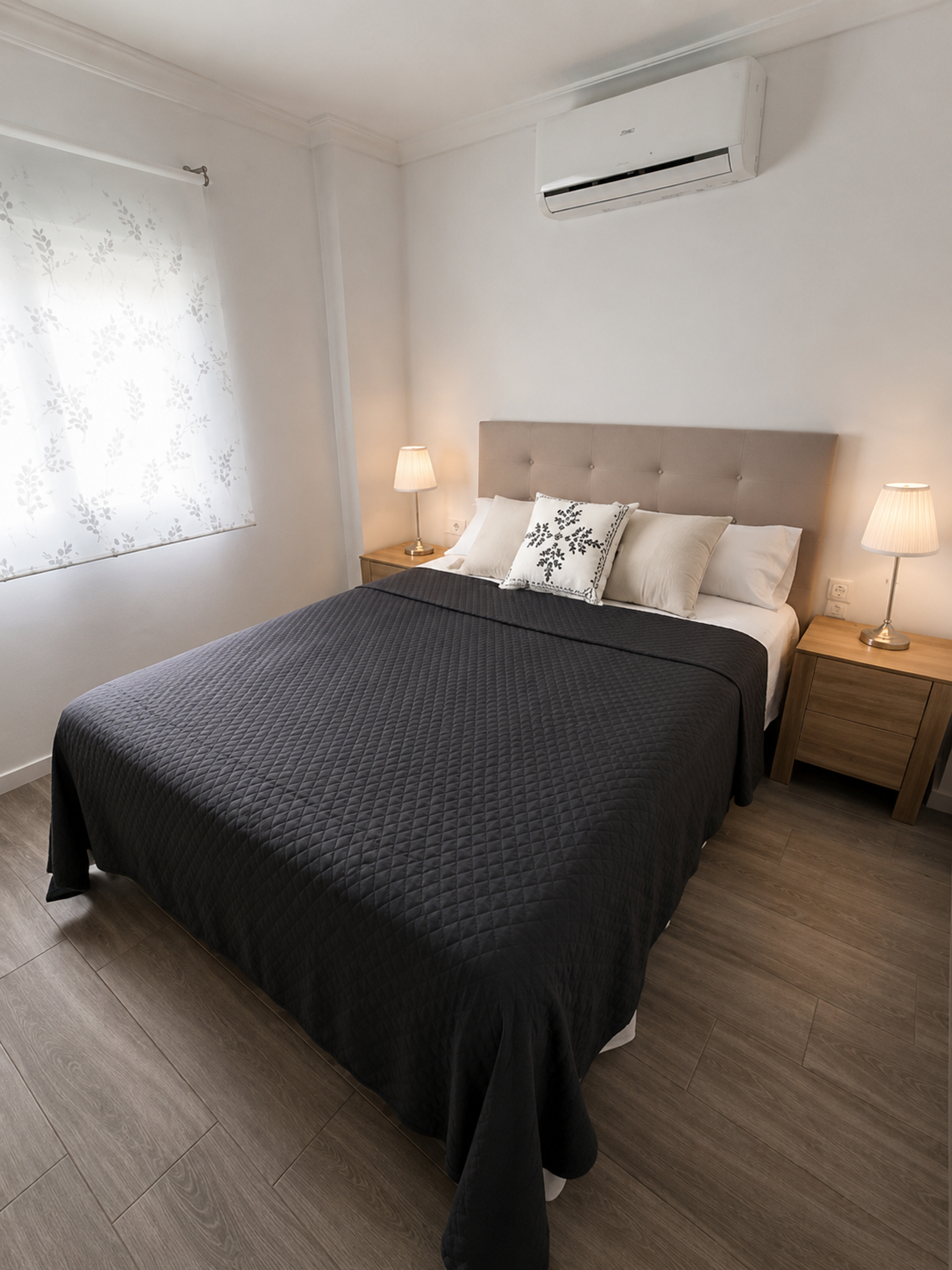 Second bedroom with dark bedspread