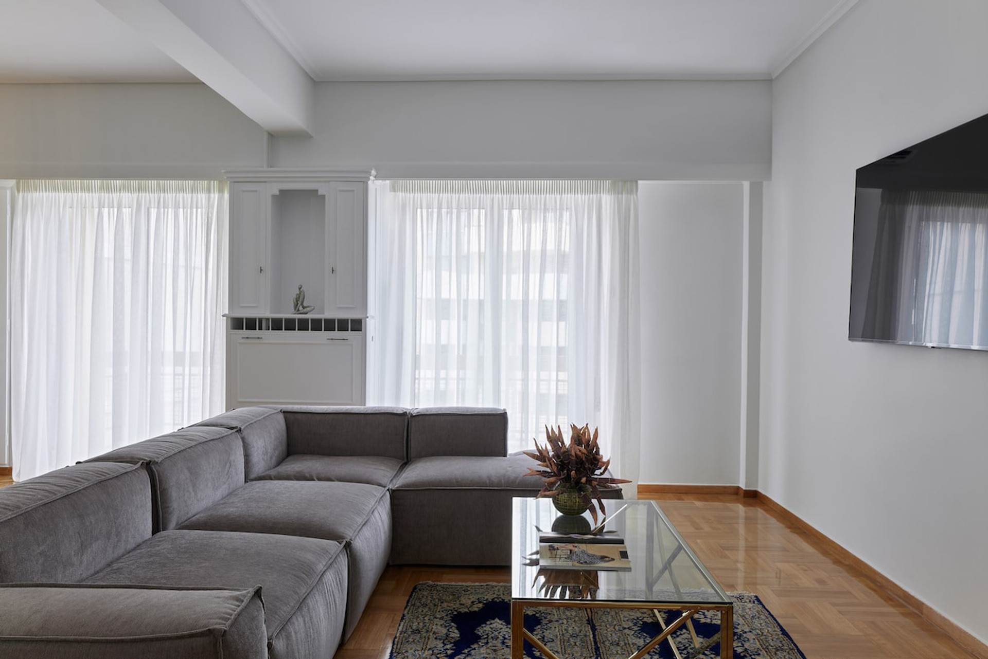 The spacious living room with a smart TV