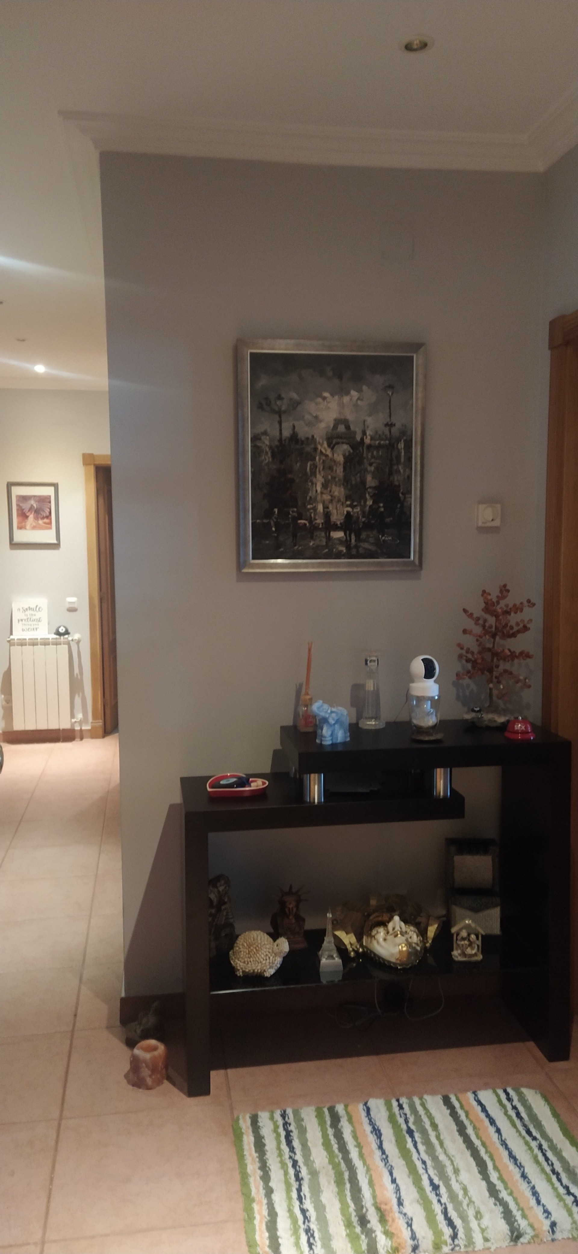Hallway with shelf and artwork