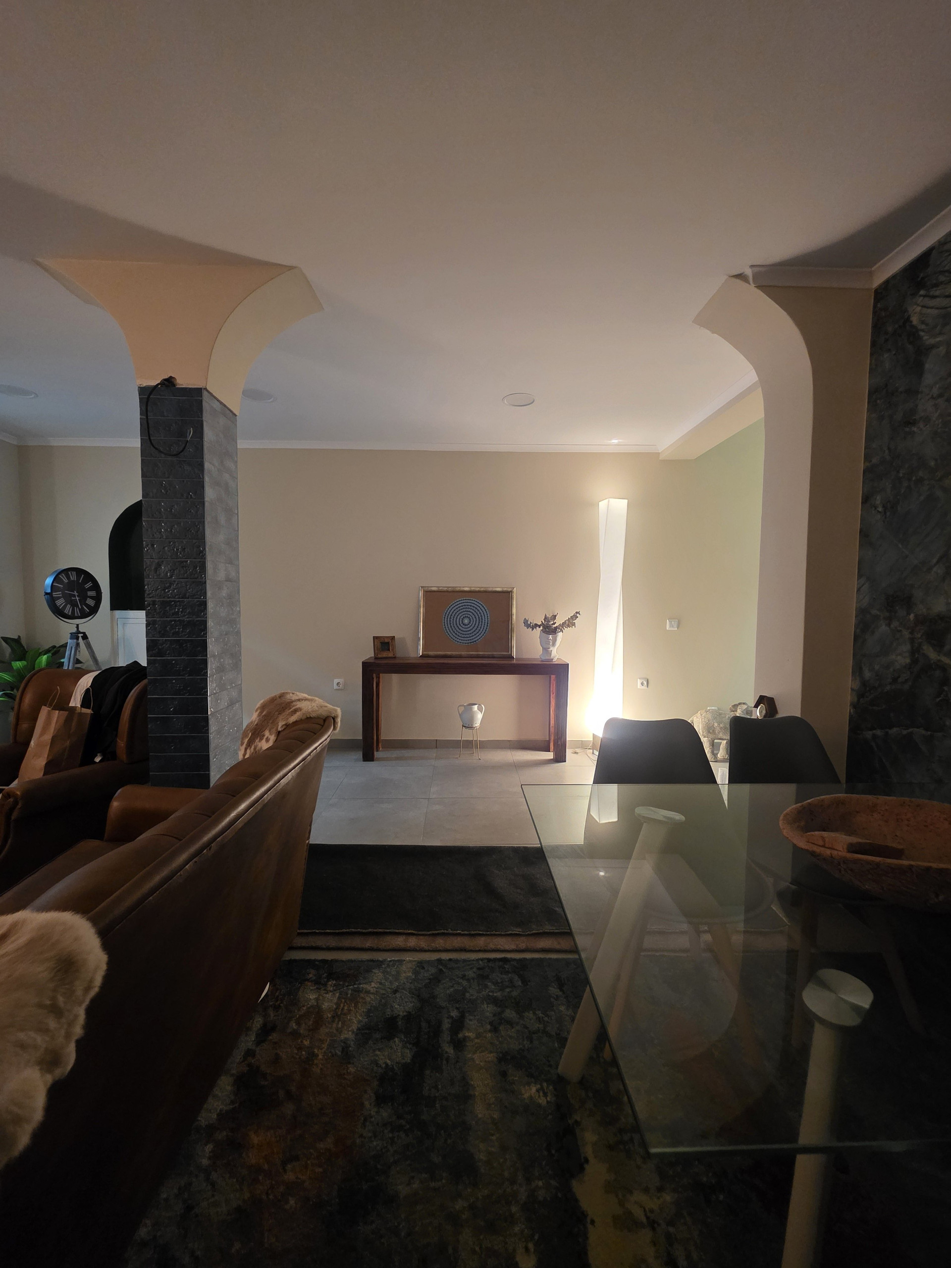 Open living and dining area with arches